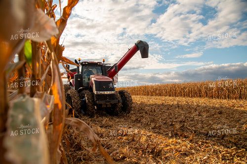 Grain Cart Driving alongside Combine 25563