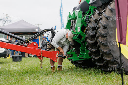 Farmer Hooking Equipment up to Hitch 52975