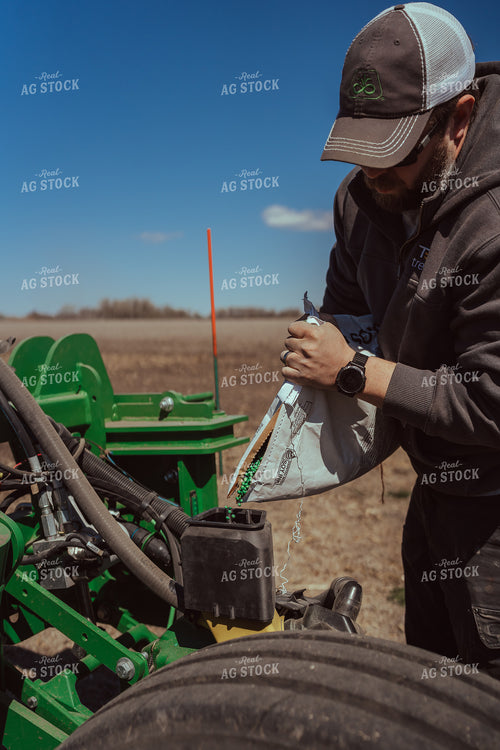 Farmer Filling Planter for Test Plot 196094