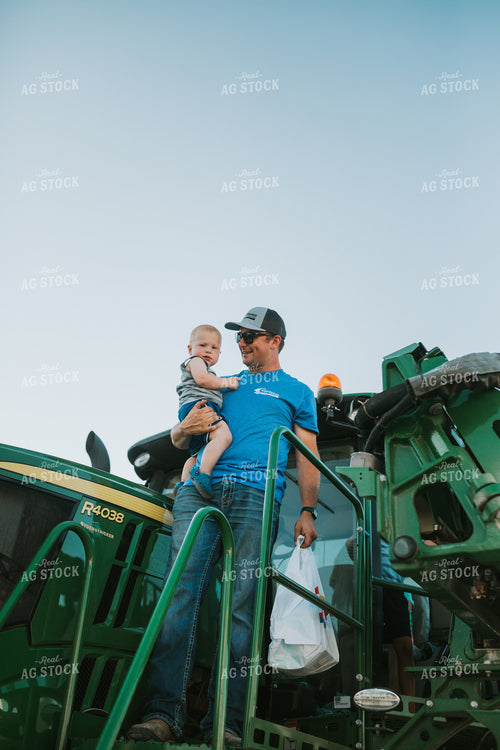 Farmer with Farm Kid on Sprayer 6228