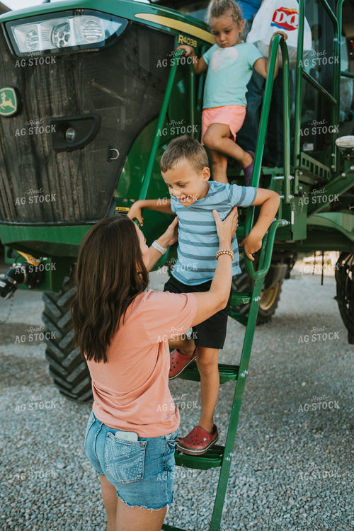 Farm Mom Helping Kids Down from Sprayer 6229