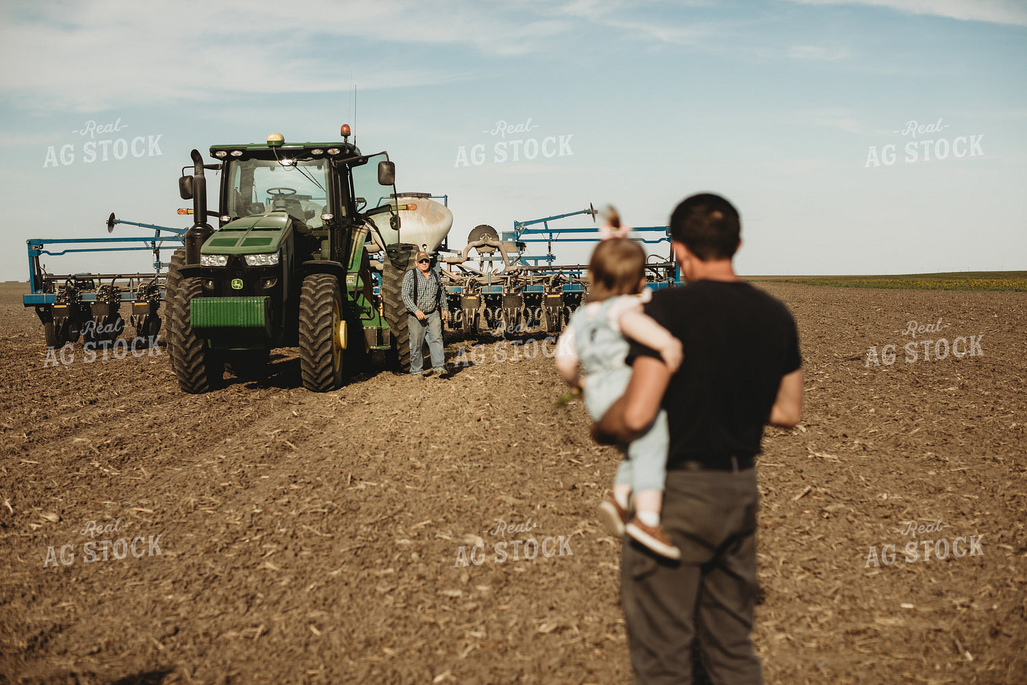 Farmer and Daughter with Tractor and Planter in Background 4187