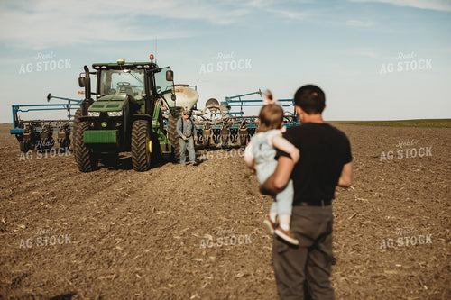Farmer and Daughter with Tractor and Planter in Background 4187