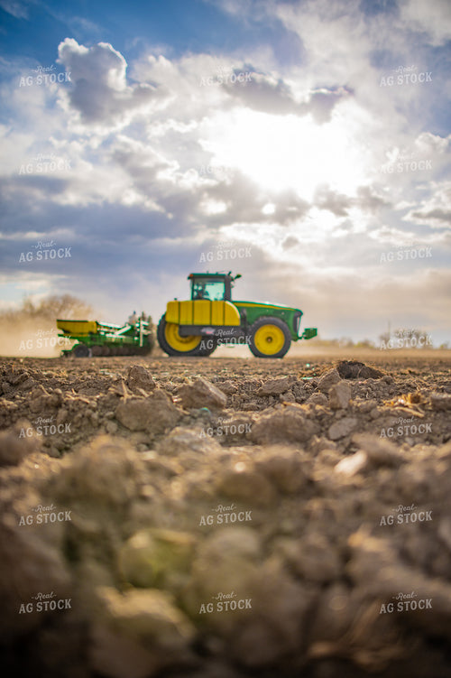 Close Up of Soil While Tractor Plants in Background 56647