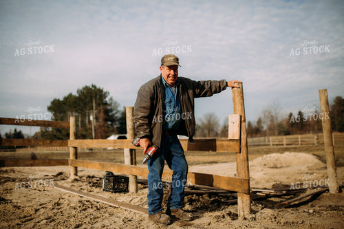 Farmer Putting up Fence 169056