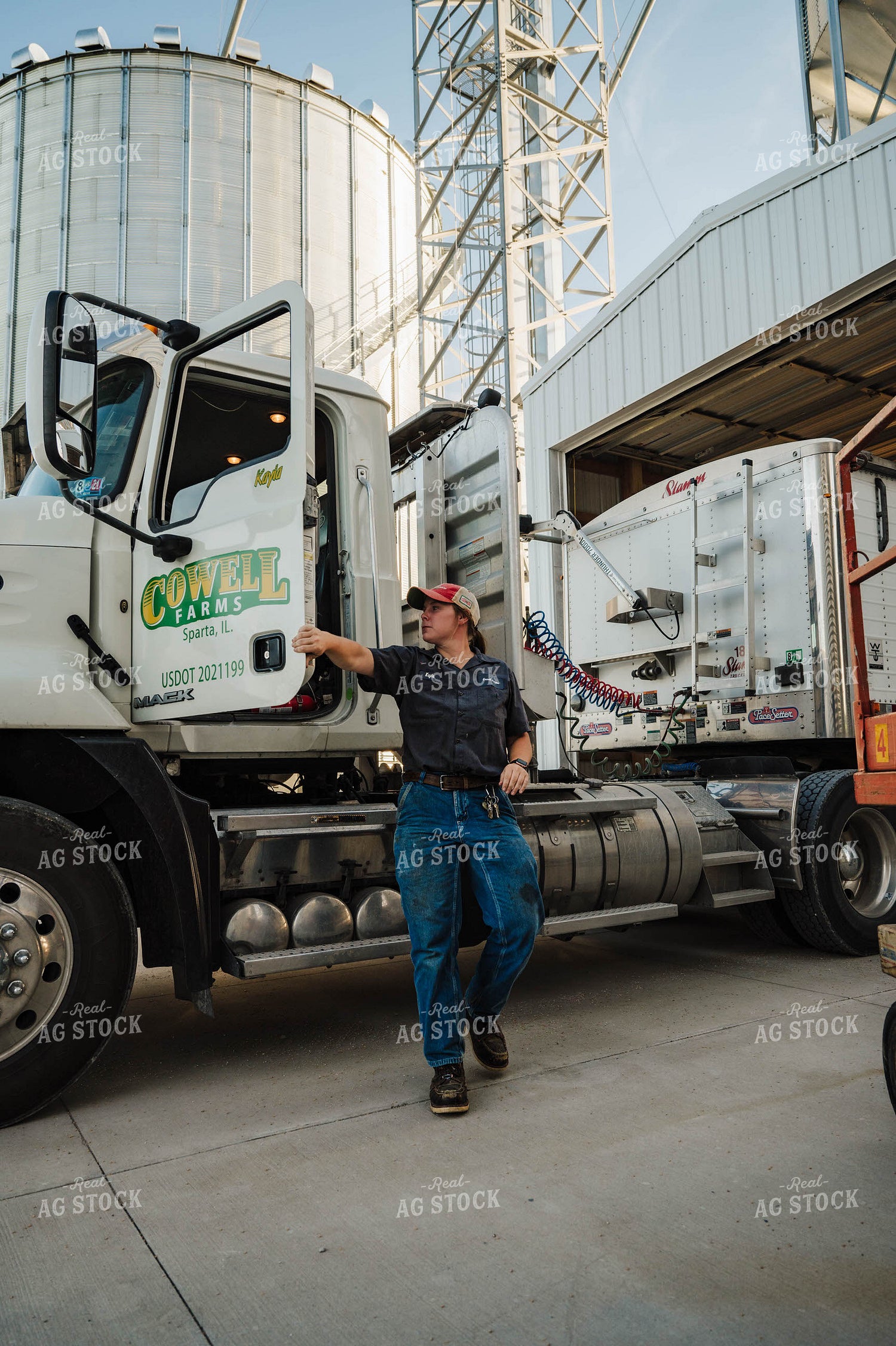 Female Farmer Climbing out of Semi 115253