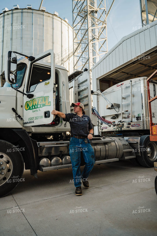 Female Farmer Climbing out of Semi 115253