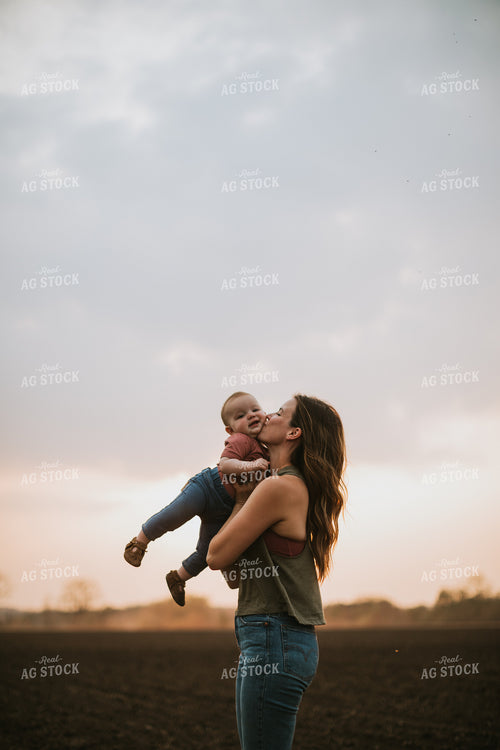 Farm Mom with Farm Kid in Field During Planting 5702