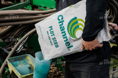 Farmers Pours Seed into Planter 133009
