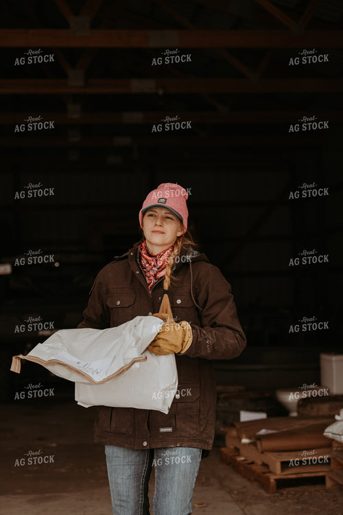 Female Rancher Carrying Feed Bag 61183