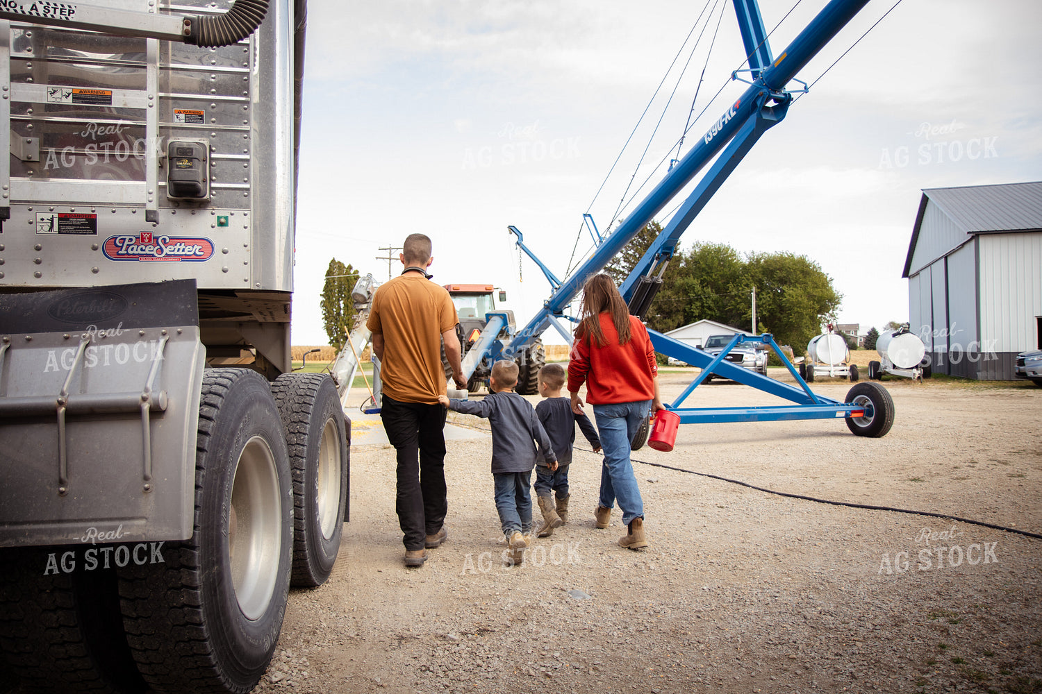 Farm Family Dumping Corn into Grain Pit 268101