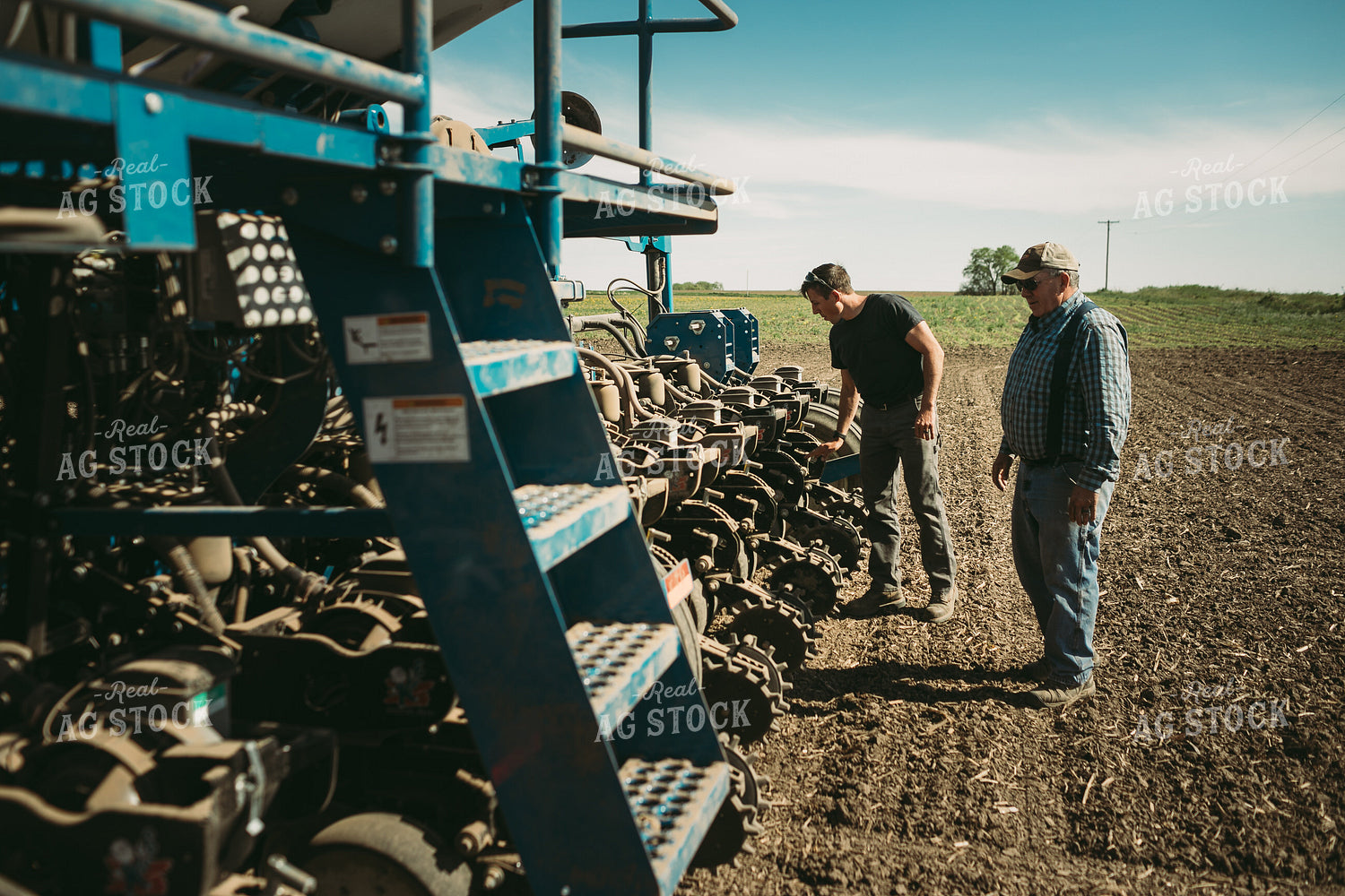 Farmers Adjusting Planter 4269