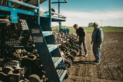 Farmers Adjusting Planter 4269