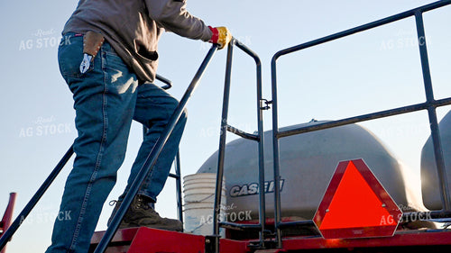 Farmer Loading the Planter with the Seed Tender 25204