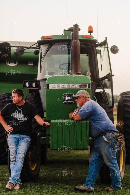 Farmers Leaning on Tractor 115088