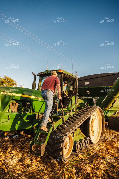 Farmer and Farm Kid Climbing into Tractor 115372