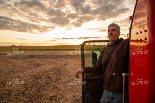Farmer Watching Harvest from Semi Cab 25696