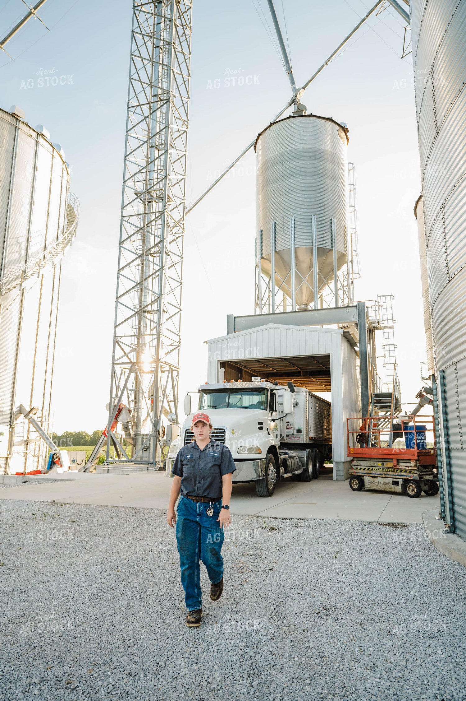 Female Farmer Walking by Semi 115285