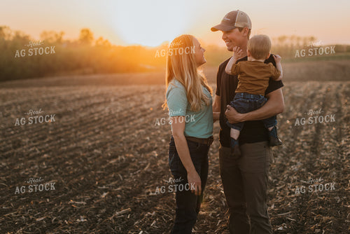 Young Couple with Child in Field at Sunset 7721