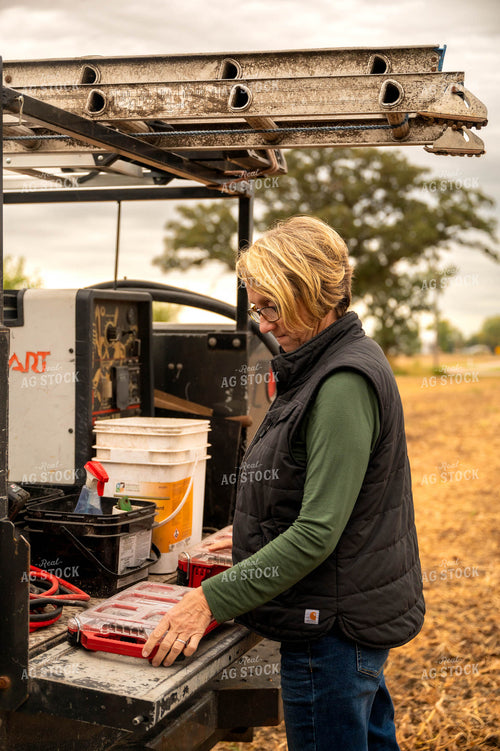 Female Farmer Getting Tools out of Service Truck 115416