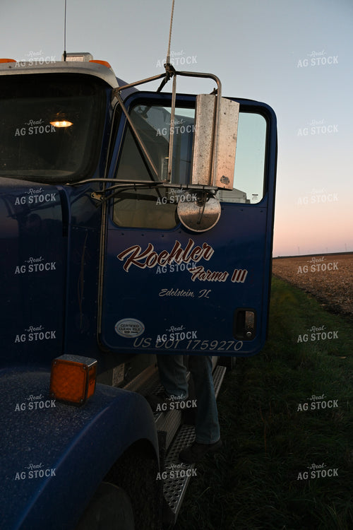 Farmer Climbing into Semi Truck 26319