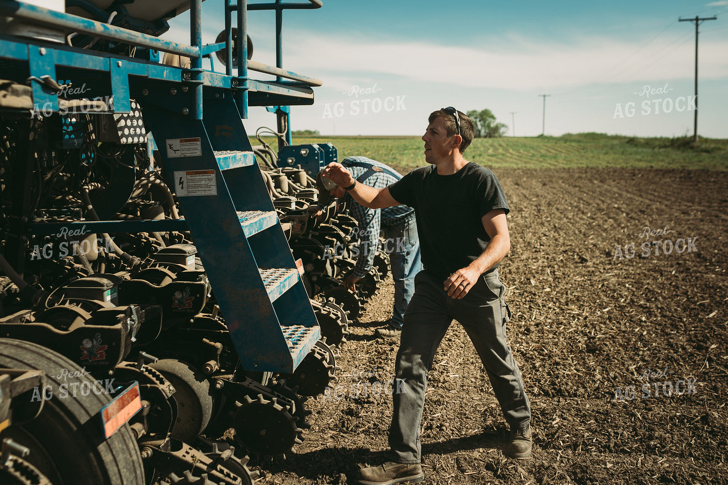 Farmers Adjusting Planter 4271