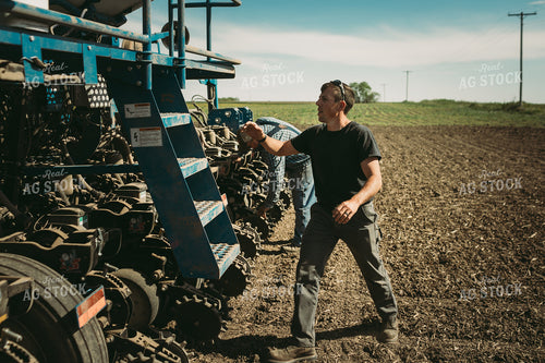 Farmers Adjusting Planter 4271