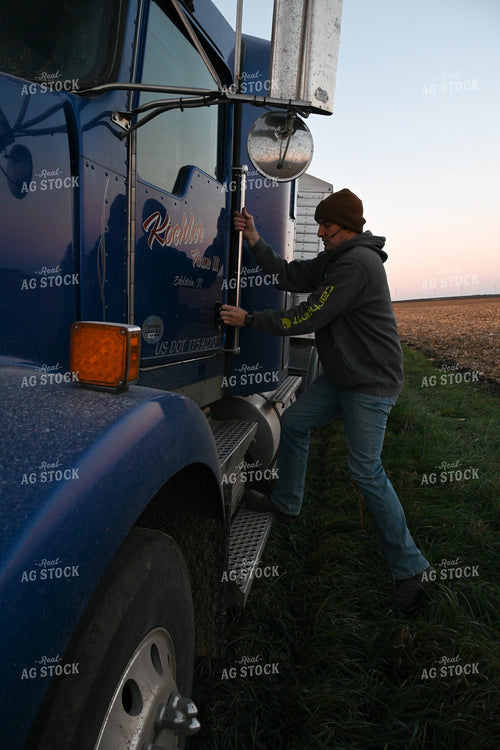 Farmer Climbing into Semi Truck 26290