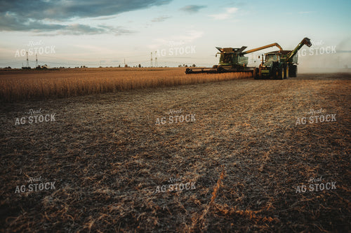 Combine Unloading on the go into Grain Cart at Sunset 3460