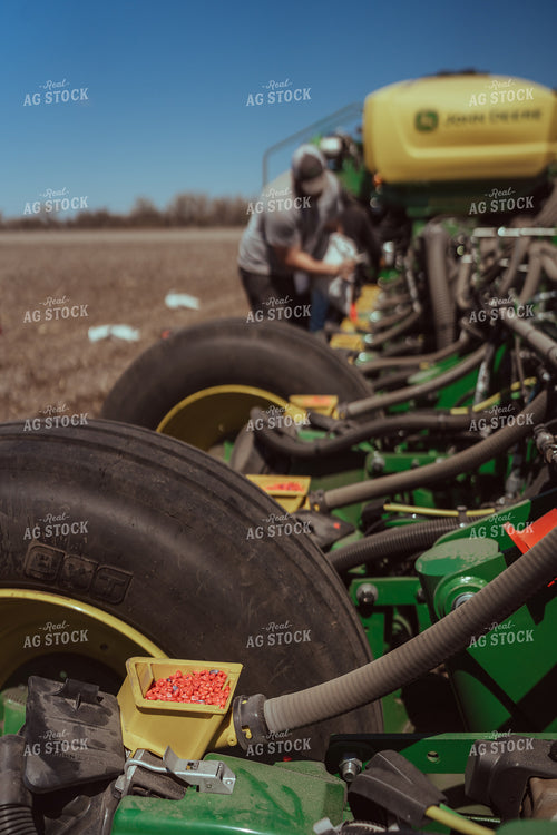 Farmer Filling Planter for Test Plot 196125