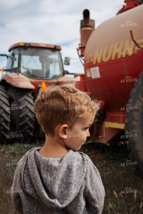 Farm Kid by Manure Spreader and Tractor 289051