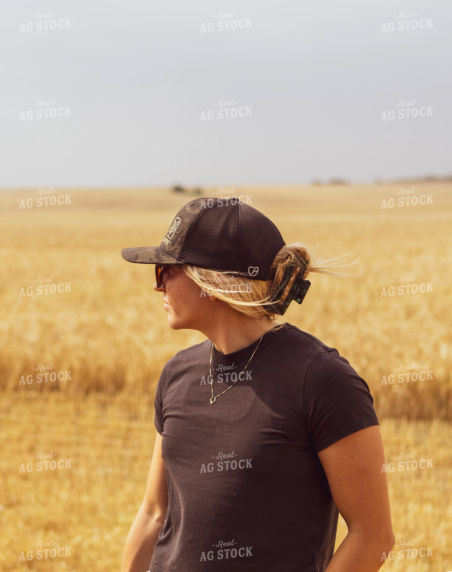 Female Farmer Standing in Dried Wheat Field 187256