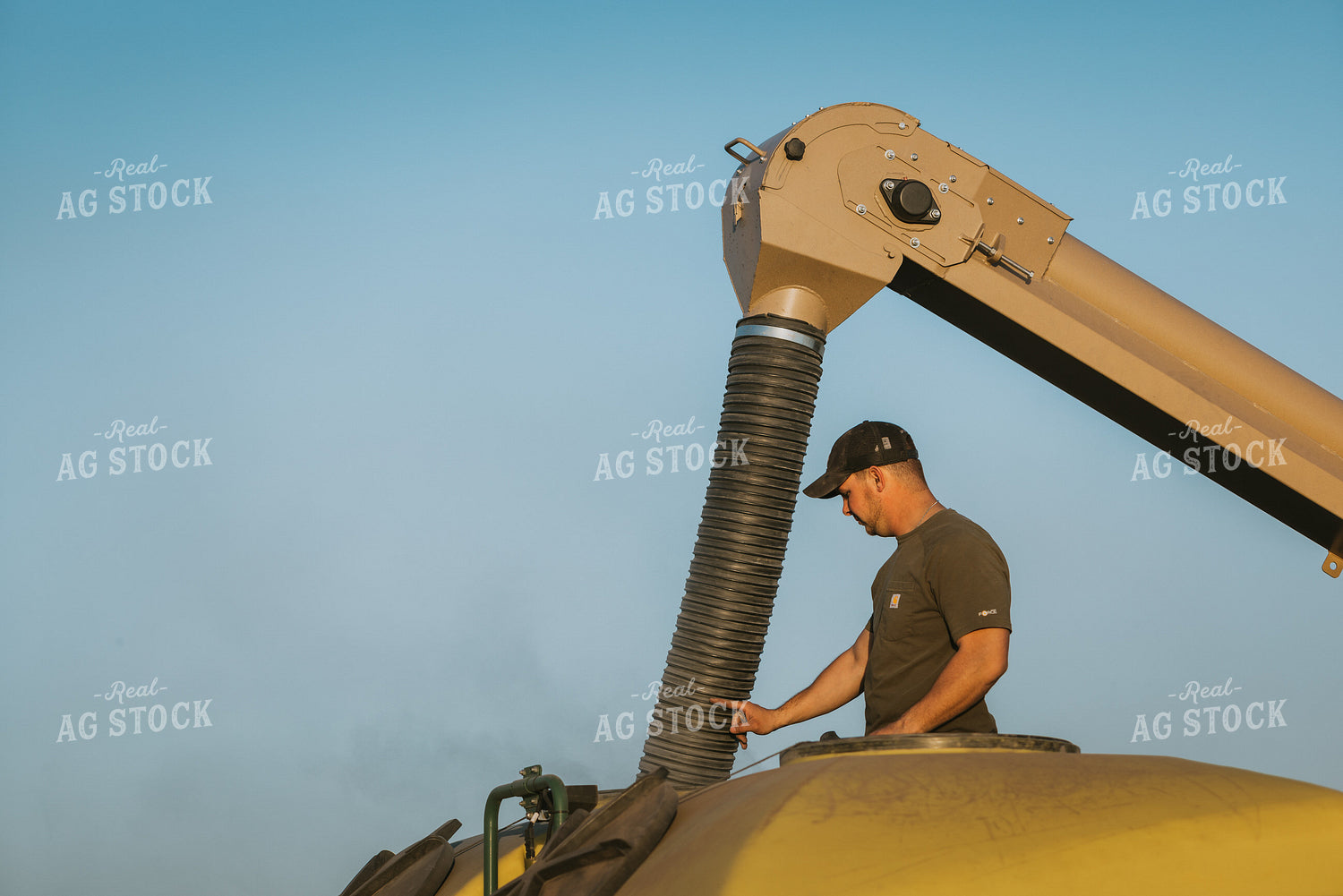 Farmer Fills Planter with Seed Tender in Field 7703