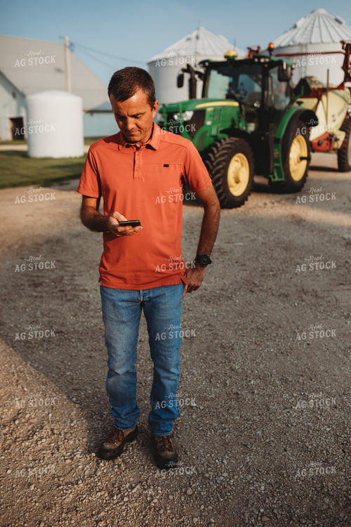 Farmer on Phone Outside of Tractor 4532
