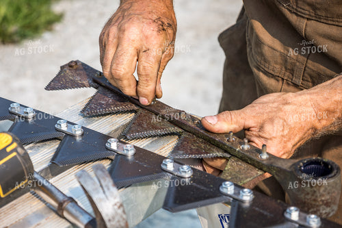 Farmer Fixing Swather 138092