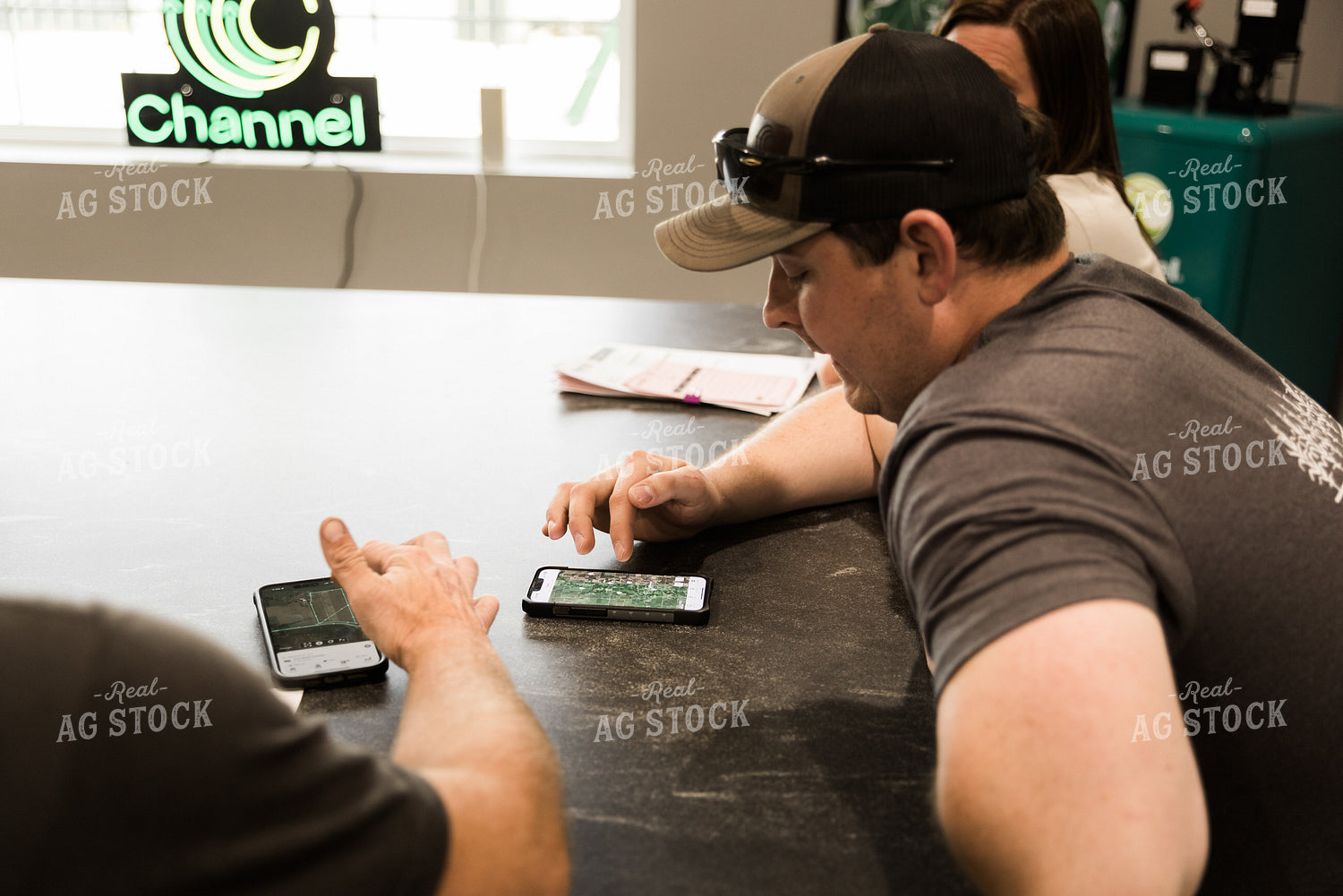 Farmers Look at Aerial View of Farmland on Phone in Office 7622