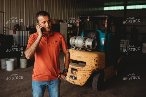 Farmer on Phone in Shop 4524
