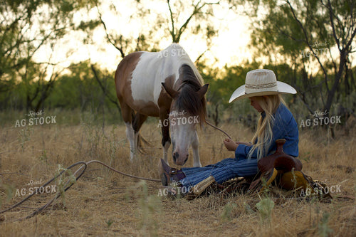 Young Cowgirl Sitting with Horse 205055