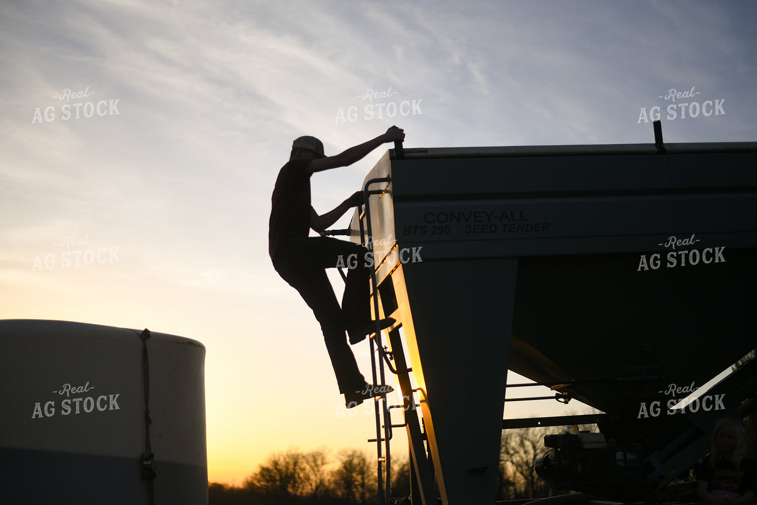 Farmer Climbing Down Seed Tender 191012