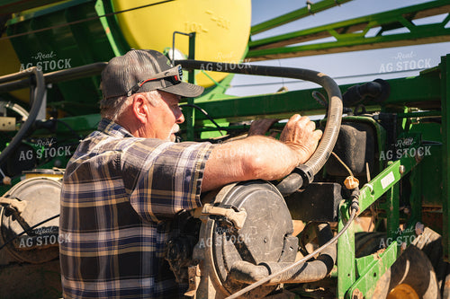 Farmer Working on Planter 128021