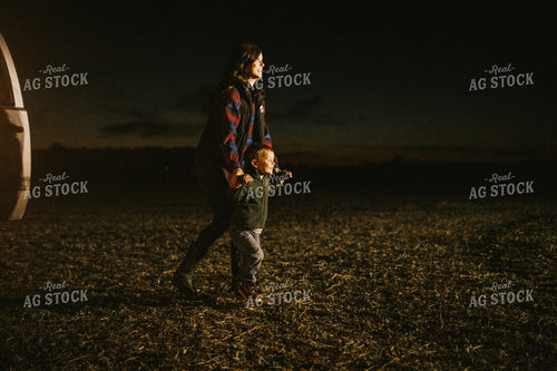 Farm Mom and Son Waiting for Tractor in Field at Night 5159
