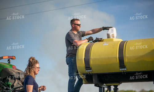Farmer Filling Planter with Starter 76370