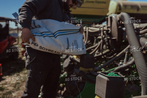 Farmer Filling Planter for Test Plot 196095