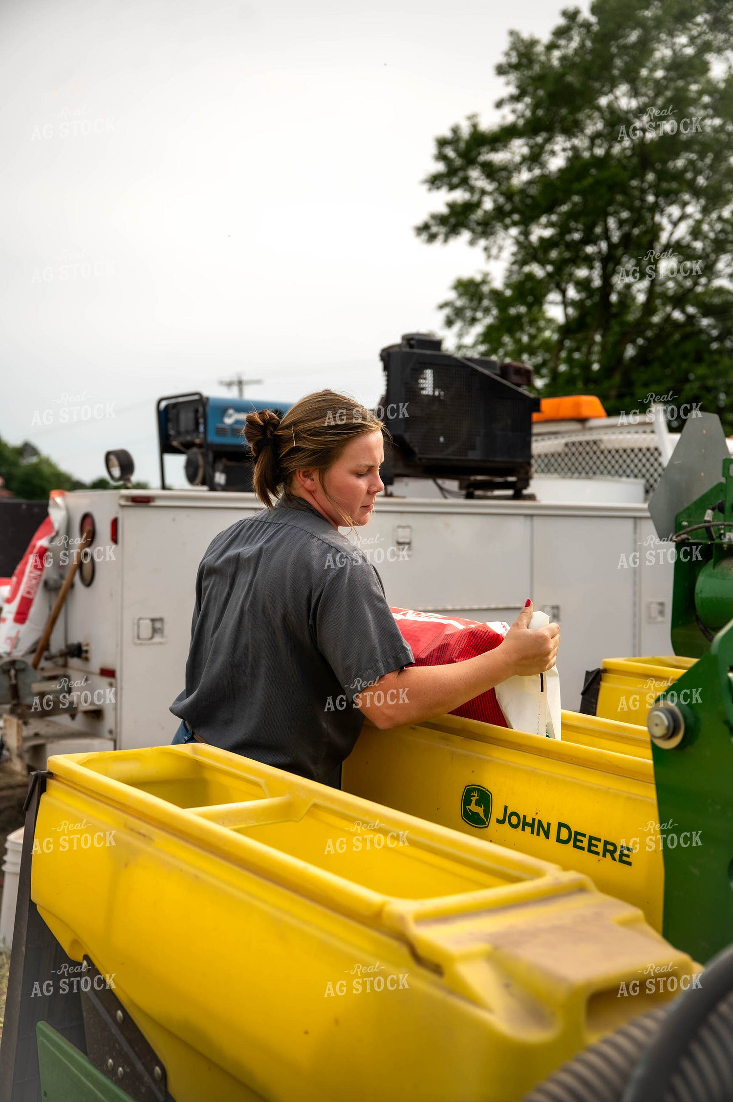 Female Farmer Filling Planter 115634