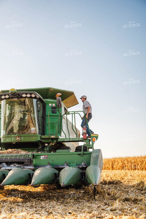 Farmer Climbing into Combine 115366