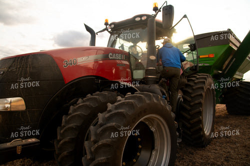 Farmer Climbing into Tractor Cab 25682