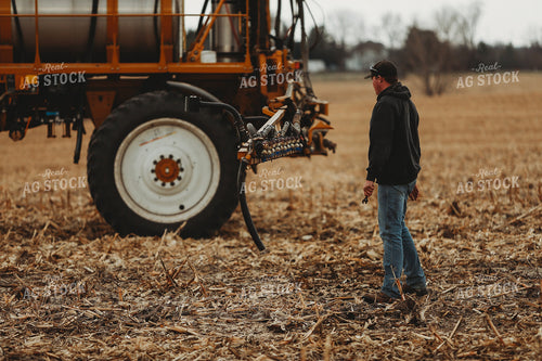 Farmer Checking Sprayer Valves 3641