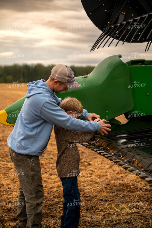 Farmer and Son Fixing Combine Head 115403