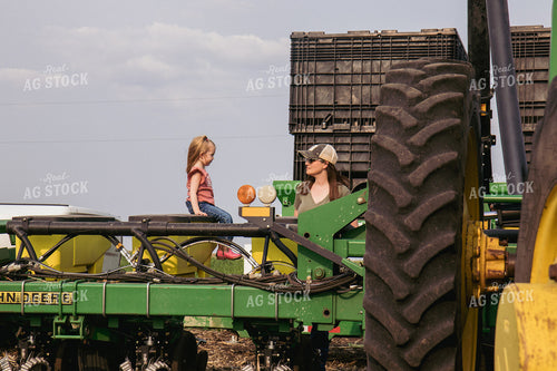 Female Farmer and Daughter Load Planter with Seed 67313