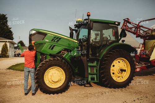 Farmer Checking Tractor Oil 4453